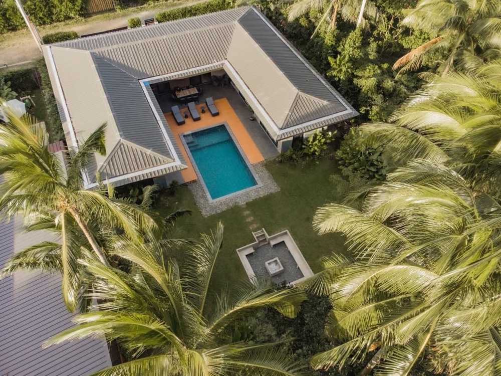 Casa Fariñas from above — pavilions around a pool, set among coconut palms.