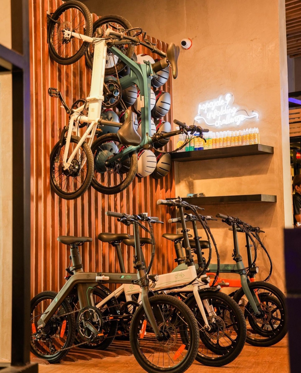 Elektric Avenue — timber-slatted wall carrying electric bikes and helmets.