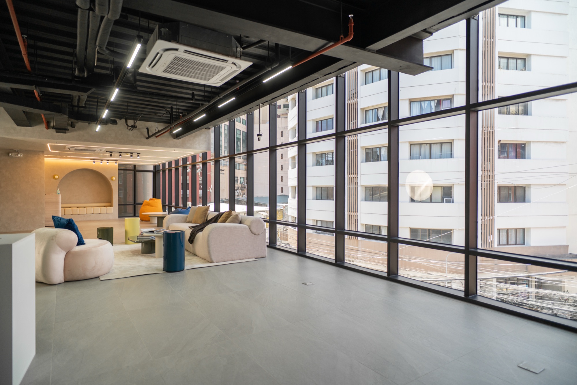 G&R Studio — completed commercial interior with a full-height glazed elevation and exposed services.