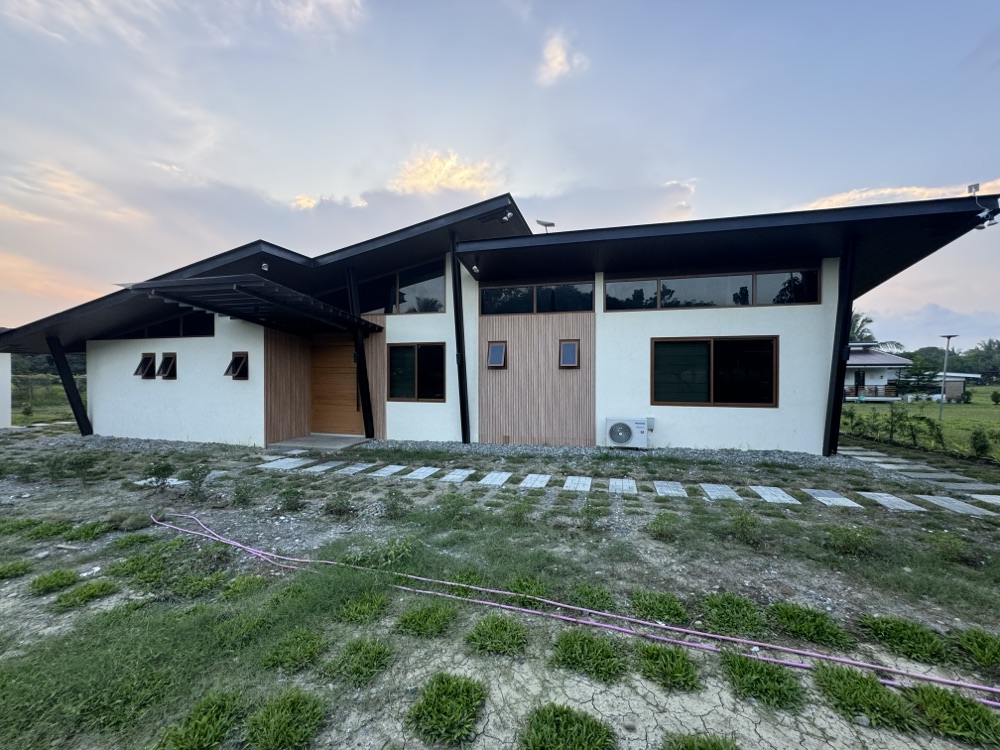 Mindoro Project — the finished house, two pitched roof planes set against one another.